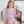 Young girl wearing a pink sea animal themed swimsuit sitting on a chair eating a popsicle, lifestyle, frontMillieloveslily.com
