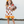 A young girl wearing a cream ground turkey themed printed dress and holding a turkey stuffed animal, lifestyle, Millie Loves Lily