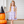 A young girl wearing a lilac halloween themed printed dress standing on a pocrh beside stacked pumpkins, lifestyle, Millie Loves lily