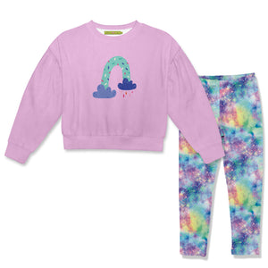 A children's two-piece outfit set featuring a light pink long-sleeve  velour sweatshirt with a pastel rainbow graphic on the chest, paired with matching leggings in a vibrant multicolor galaxy tie dye print.