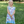 Young girls wearing a blue mermaid patterned dress standing outside in the grass, lifestyle, front - Millieloveslily.comt