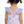 A young girl wearing a blue stripe 1-pc swimsuit with seashells and starfish and blue dot ruffles and a pink back bow, backview, lifestyle