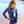 A young girl wearing a Navy Turtle patterned Rashguard and stripe swim shorts lifestyle