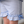 A closeup of a young girl standing wearing a purple & white striped  short , lifestyle