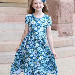 A young girls wear a  Teal Floral Hi - Low Midi Dress with short sleeves standing in front of steps outside, lifestyle - Millieloveslily.com