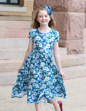 A young girls wear a  Teal Floral Hi - Low Midi Dress with short sleeves standing in front of steps outside, lifestyle - Millieloveslily.com