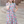 A young girl wearing a turquoise floral hi-low mid-length dress with short sleeves standing in front of steps outside, lifestyle