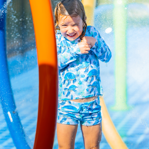 Girls Turquoise Turtle themed Long Sleeve Rashguard Set standing in a water park, lifestyle- Millieloveslily.com