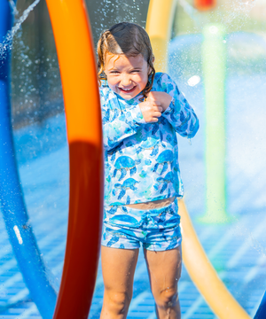 Girls Turquoise Turtle themed Long Sleeve Rashguard Set standing in a water park, lifestyle- Millieloveslily.com
