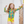 A young girl wearing  a yellow Neon Hawaiian print Long Sleeve Rashguard & swim short set standing in front of a white background, lifestyle UPF 50+, Millieloveslily.com