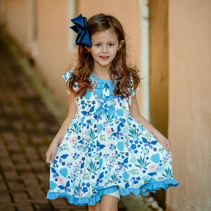 A young girl wearing a  Blue butterfly & Floral printed Angel - sleeve Dress - Millieloveslily.com