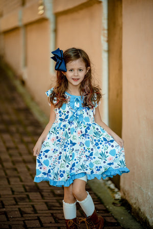 A young girl wearing a  Blue butterfly & Floral printed Angel - sleeve Dress - Millieloveslily.com