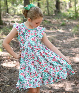 Kids Jade Meadow Flower Angel - Sleeve Dress, outside in a wooded area, front- Millieloveslily.com