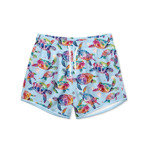 Kids Pale Blue Tie Dye Turtle patterned swim trunks on a white background, front -