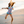 Young girl wearing a floral swimsuit jumping in the air on the beach, lifestyle, front - Millieloveslily.com