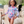 A young girl wearing a Coral flower Ruffle - Accent One - Piece Rashguard standing on the beach, lifestyle, front - Millieloveslily.com