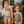Two young girls wearing leopard skin swimsuits holding hands standing outside, lifestyle, front- Millieloveslily.com