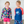A young girl and boy wearng rashguard sets standing in front of a white wall, lifestyle