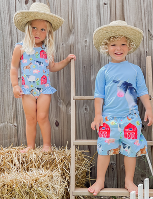 A young boy and girl wearing matching blue barn amimal themed swimsuits wearing strawhats, lifestyle, front- Millieloveslily.com