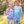 A young boy and young girl wearing matching ocean themed swimsuits holding toys standing in the grass, lifestyle, front Millieloveslily.com