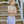 Boy wearing blue stripe swim trunks in front of steps outside, front