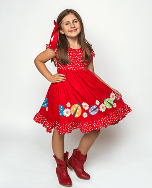 Young Girl wearing a red Ladybug Border patterned Dress & Shorts standing on an off white background, lifestyle, front - Millieloveslily.com