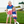 A young girl and young boy standing outside wearing matching red, white & blue stars and stripe outfits with their arms around each other, lifestyle