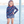 A young girl wearing a long sleeve rashguard in  Red,Wht,Blue Stars & navy Stripe swim shorts standing outside, lifestyle, front - Millieloveslily.com