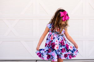 girls wearing a periwinkle floral  Angel Wing Dress standing in front of a white background, lifestyle  - Millieloveslily.com